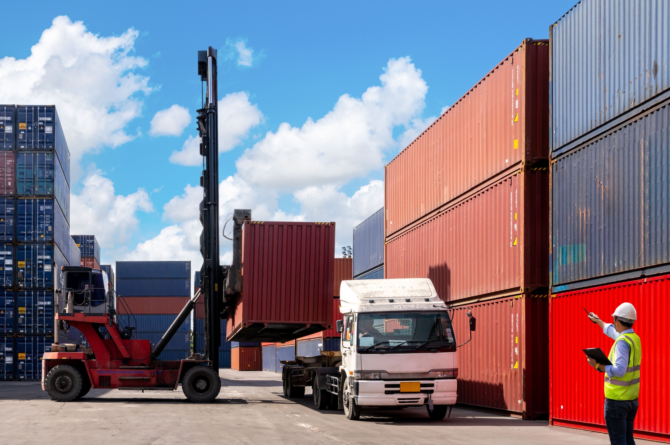 A foreman organising containers from a cargo ship.