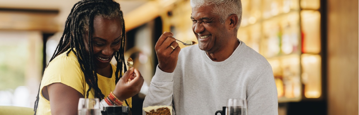 A couple laughing together at a café.
