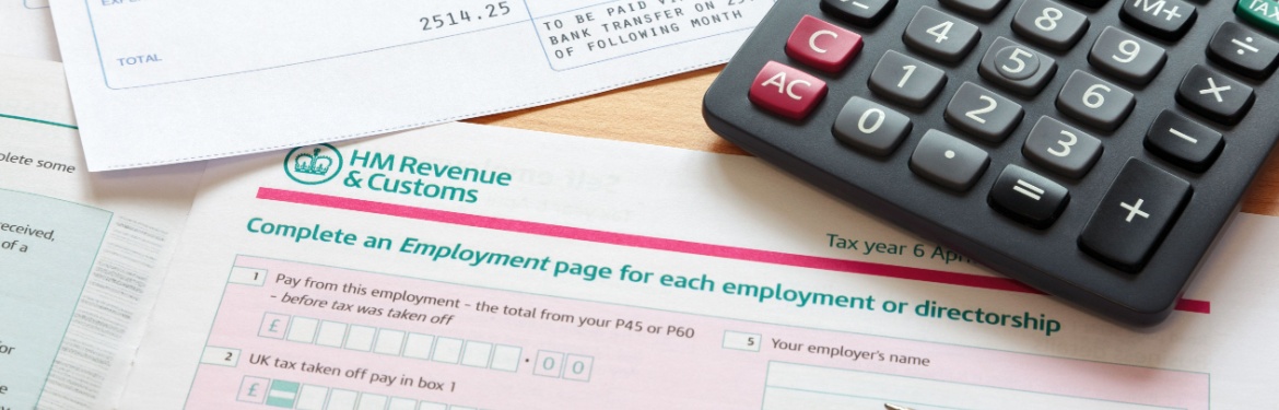 Paperwork relating to a tax return, with calculator and pen lying on it