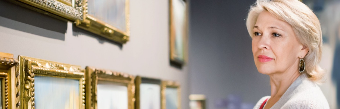 A woman looking at art in a gallery.