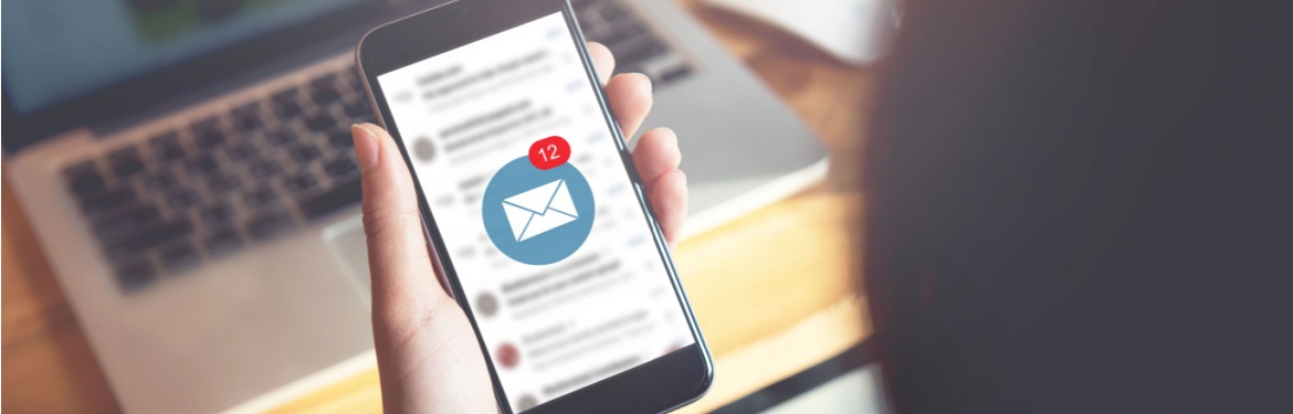 A person looking at their email on their phone.