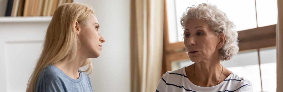 A mother and adult daughter talking.