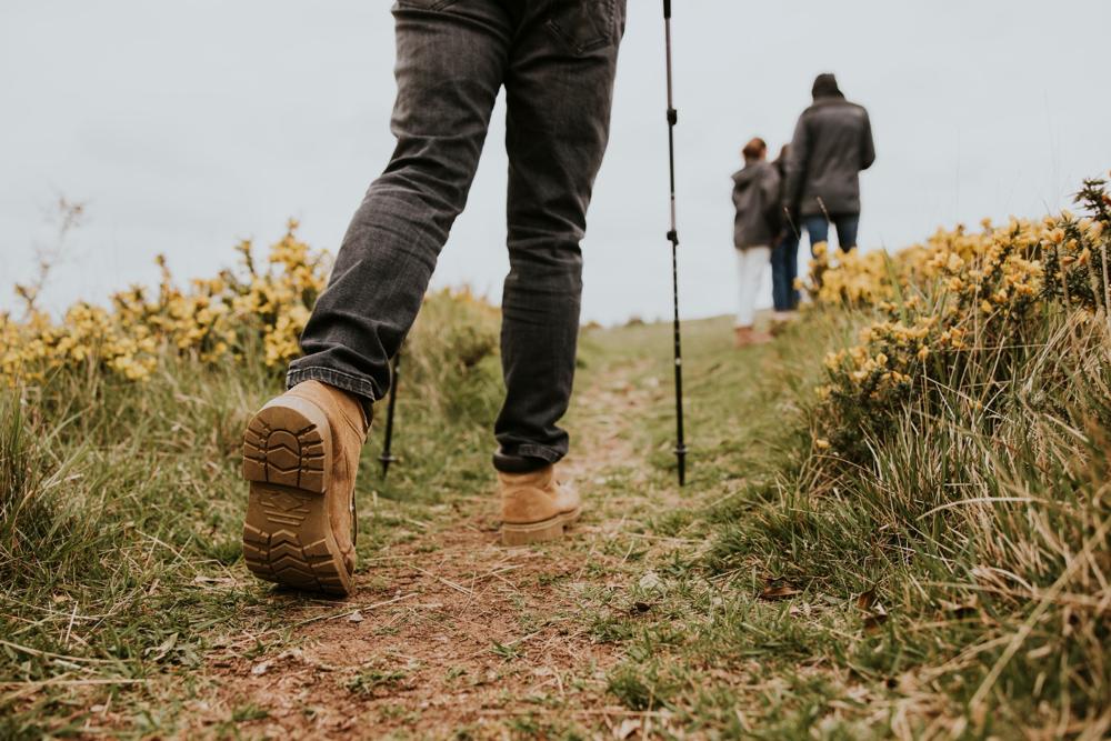 A group of people walking along a hiking trail.