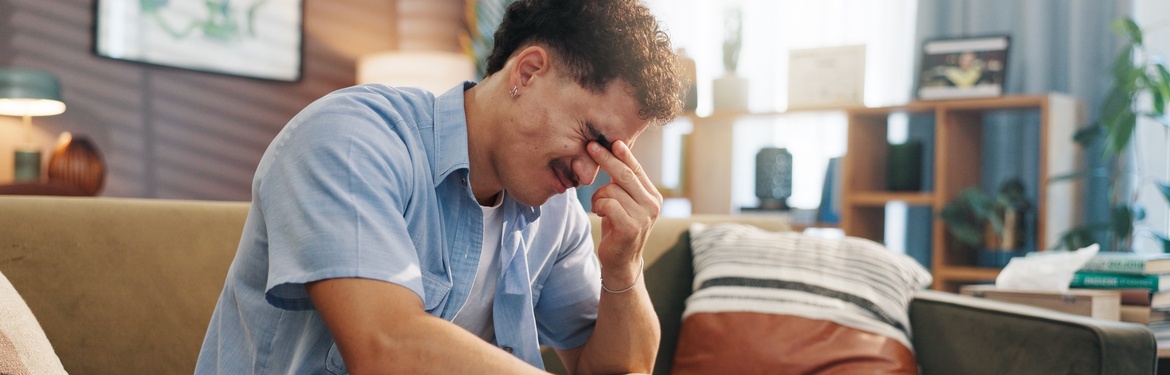 A stressed man with his head in its hand.