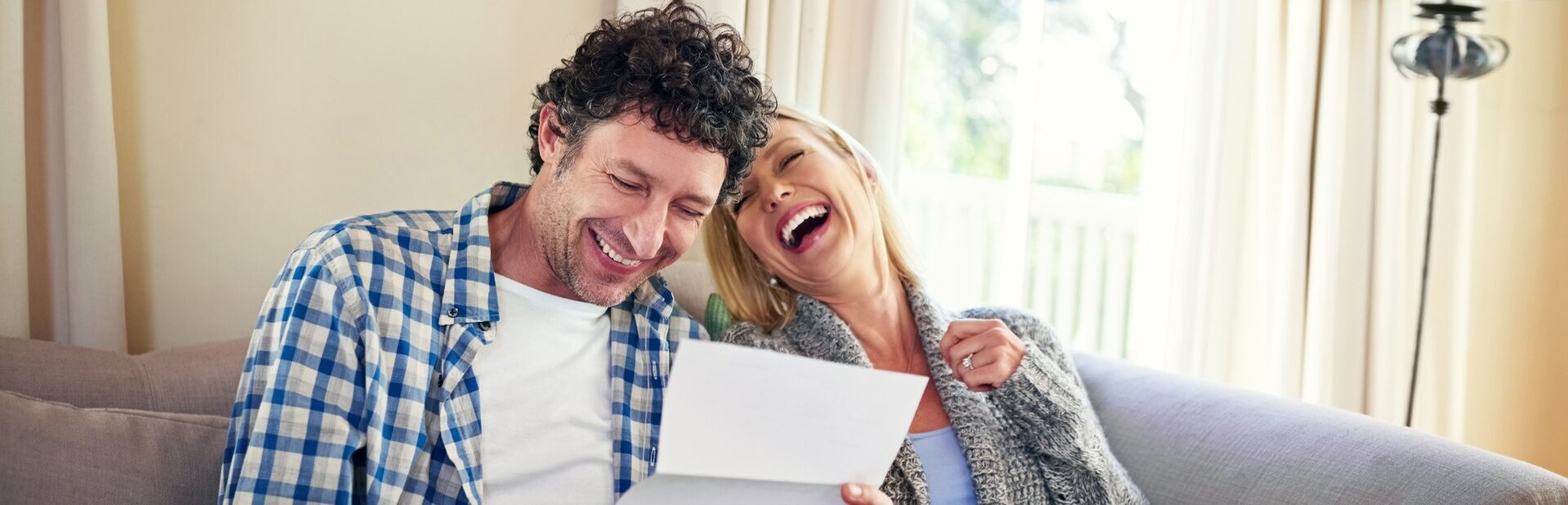 A happy couple reviewing paperwork.