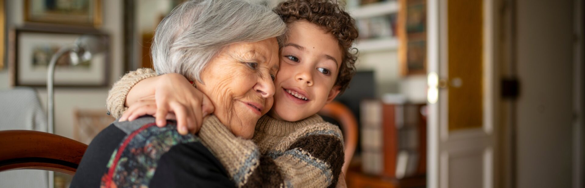 A woman hugging her grandchild.