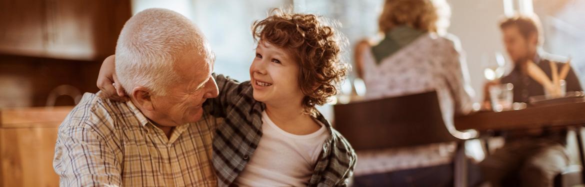 Grandfather hugging his grandchild.