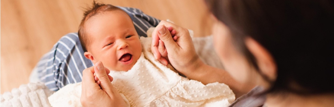 A mother holding a baby.