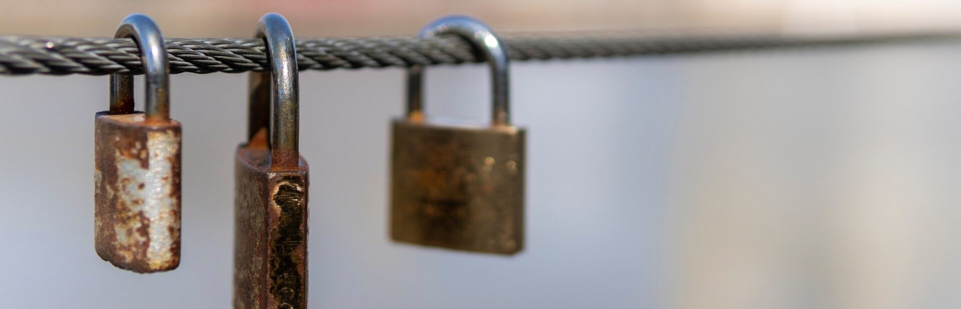 Three padlocks on a chain.