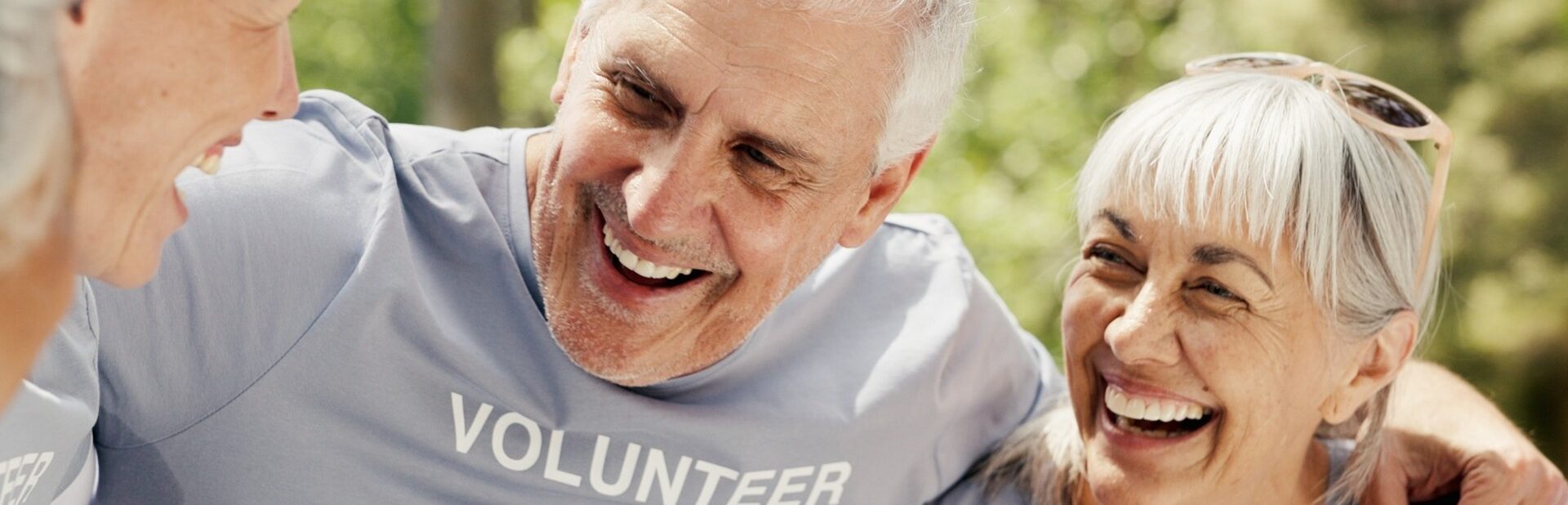 Happy senior people wearing “volunteer” t-shirts