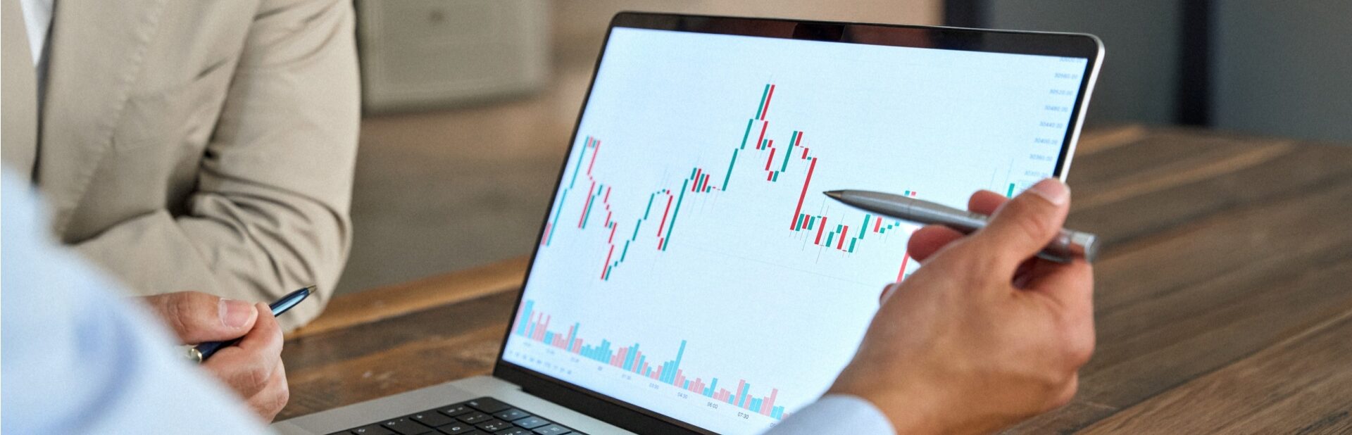 A man reviewing stock market movements on a laptop.