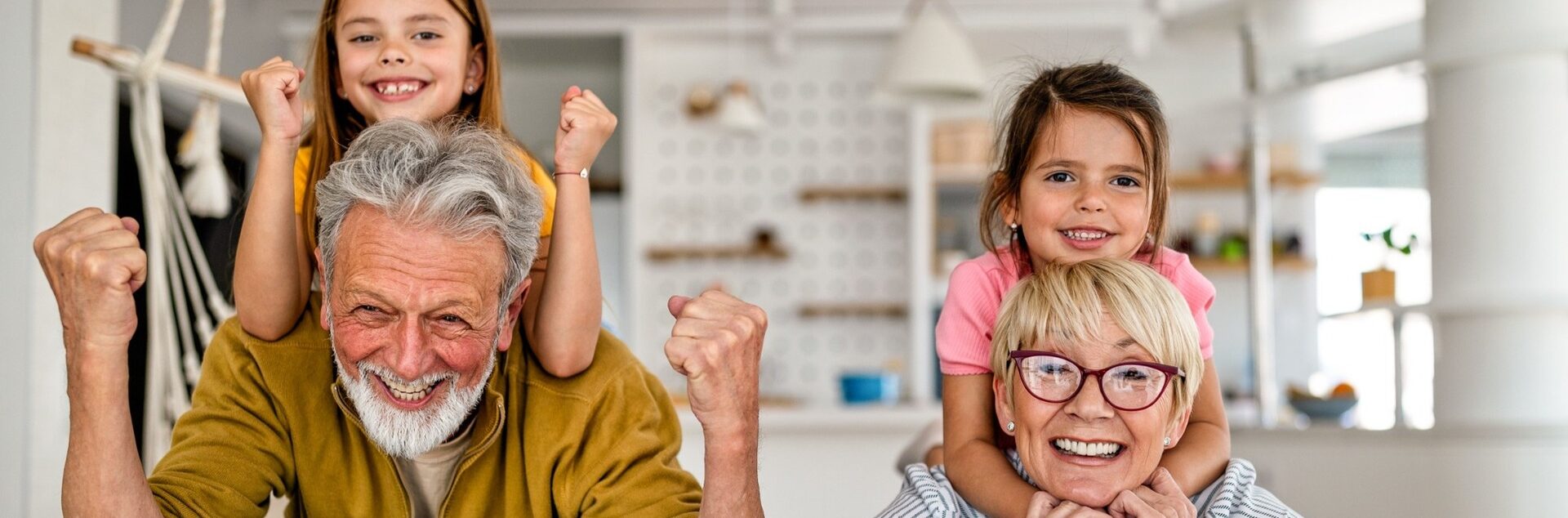 Grandchildren and grandparents having fun together in their kitchen
