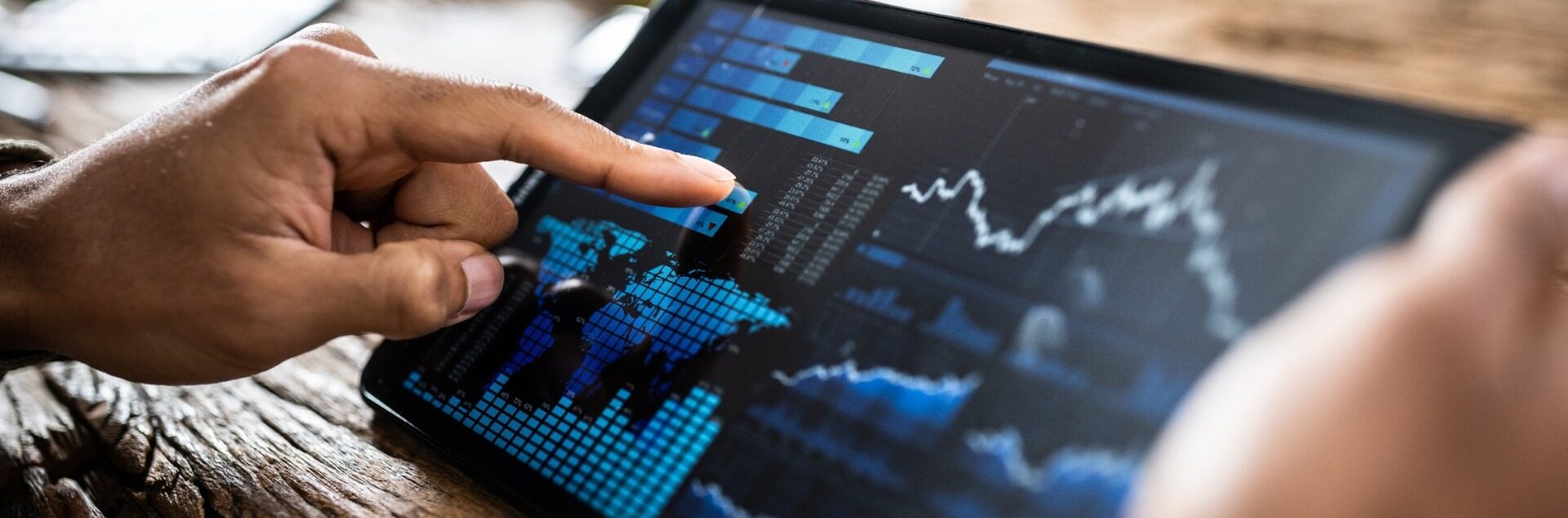 A person reviewing investment performance on a tablet.